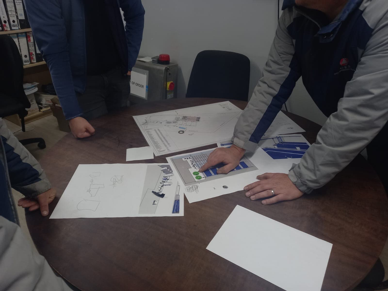 CES team reviewing engineering drawings for an abalone-farm purging system